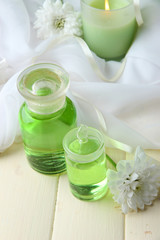 Plakat Glass bottles with color essence, on wooden background