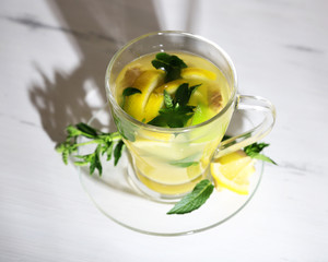 Cup of tea with ginger on wooden table
