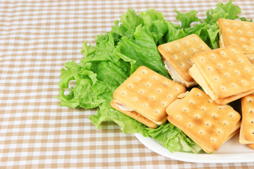 Sandwich crackers with cheese on tablecloth