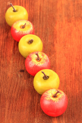 Small apples on wooden background