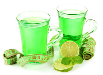 Two transparent cups of green tea and measuring tape isolated