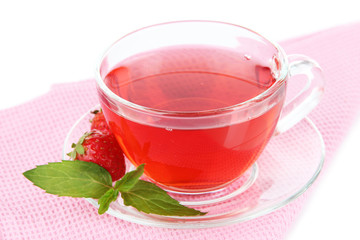 Delicious strawberry tea on table on white background