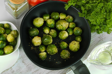 Fresh brussels sprouts in pan with vegetables and spices