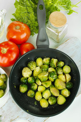 Fresh brussels sprouts in pan with vegetables and spices