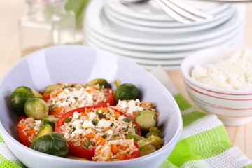 Stuffed tomatoes in bowl on wooden table close-up