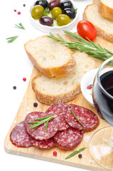 antipasto - salami, bread, olives and glass of wine isolated