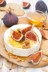 Camembert cheese with honey, figs, walnuts and crackers
