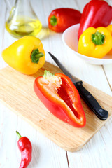 fresh sweet pepper on kitchen board and knife
