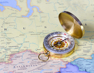 gold compass on map of Russia
