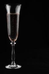 Champagne in a glass on a black background