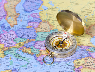 gold compass on map of Europe