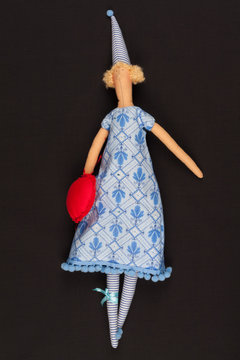 doll with red bag