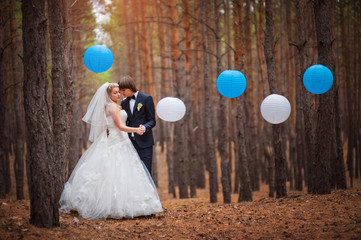happy bride and groom walking in the forest