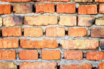 Old brick wall. Rough burnt crooked old red brick wall.