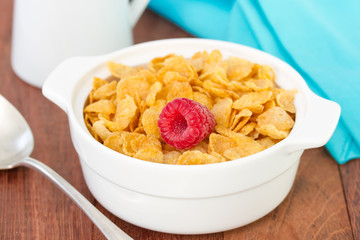 flakes with raspberry in white bowl