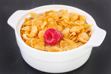 flakes with raspberry in white bowl
