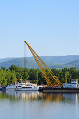 Fototapeta premium Damaged industrial boats at the bay