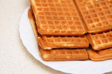 Stack of sweet belgian waffles on plate