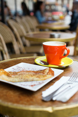 Coffee and pancake in a Parisian street cafe