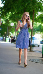 Young woman with mobile phone in the street