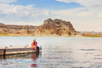 Fototapeta na wymiar A couple on a honeymoon trip at Lake Powell, Arizona