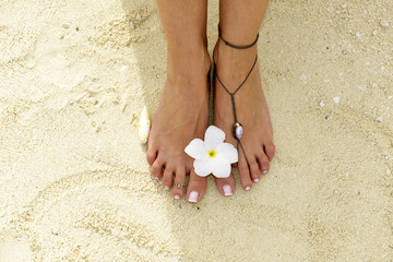 Woman feet in the sand