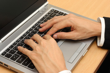 businessmans hands  typing laptop