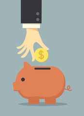 business hand saving money in piggy bank