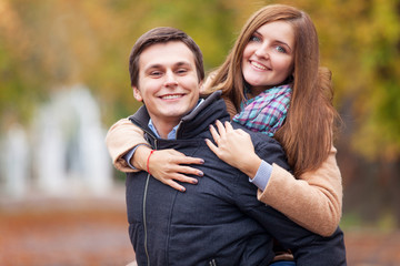 Teen couple in the autumn park