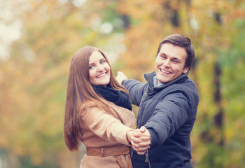 Teen couple in the autumn park