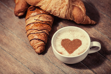 Cup of coffee with french croissant