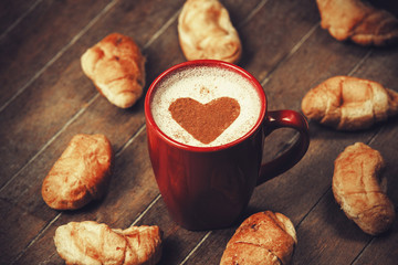 Cup of coffee with french croissant