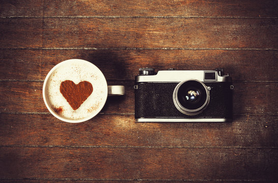Cup of coffee with retro camera