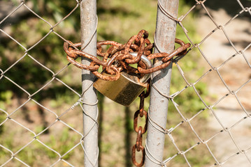 Iron fence with padlock and chain