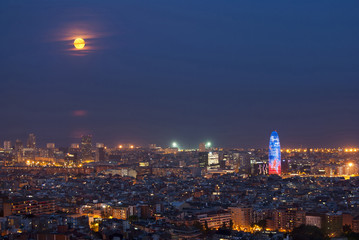 Barcelona at night with full moon, Spain