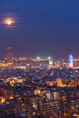 Fototapeta na wymiar Barcelona at night with full moon, Spain