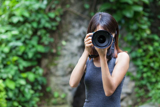 Female photographer takes photo