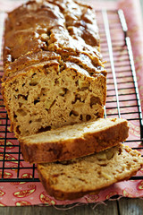 Cake with pieces of apples sliced on a cooling rack
