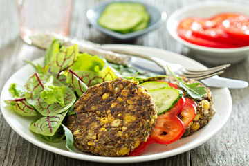 Vegan chickpeas burgers with salad and vegetables
