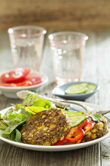 Vegan chickpeas burgers with salad and vegetables