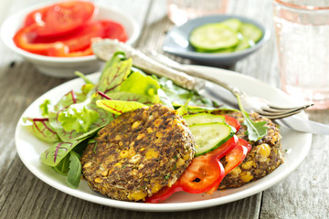Vegan chickpeas burgers with salad and vegetables