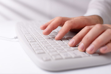 Man typing on a computer keyboard
