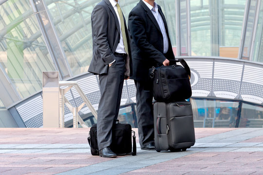 Two businessman with a business luggage.