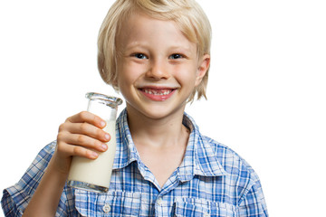 Close-up of happy boy holding bottle of milk.