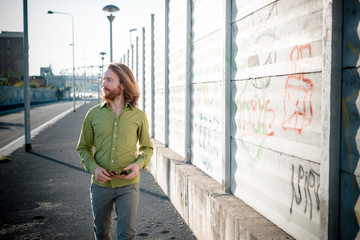 stylish hipster model with long red hair and beard lifestyle