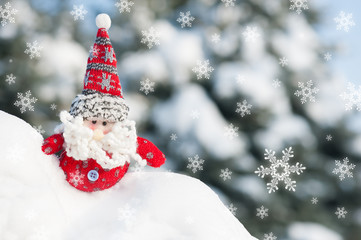 santa toy in snowdrift with snowfall