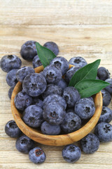 Blueberries in wooden bowl with copy space