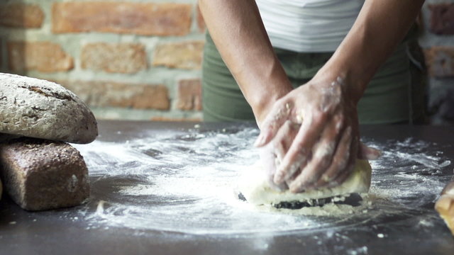 woman kneading the dough, slow motion at 60 fps