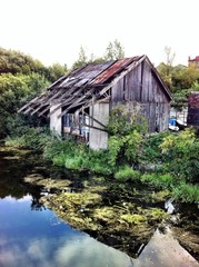 Fototapeta na wymiar abandoned derilict old warehouse next to canal in leeds uk 