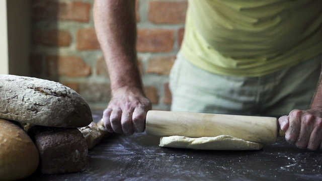 man rolling the dough, slow motion at 240 fps
